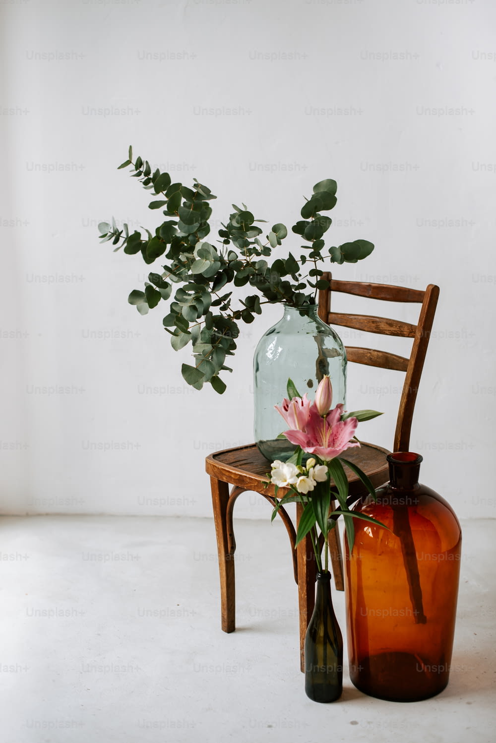 a chair with a vase and a vase with flowers on it