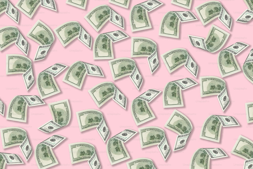 a lot of money falling down on a pink background