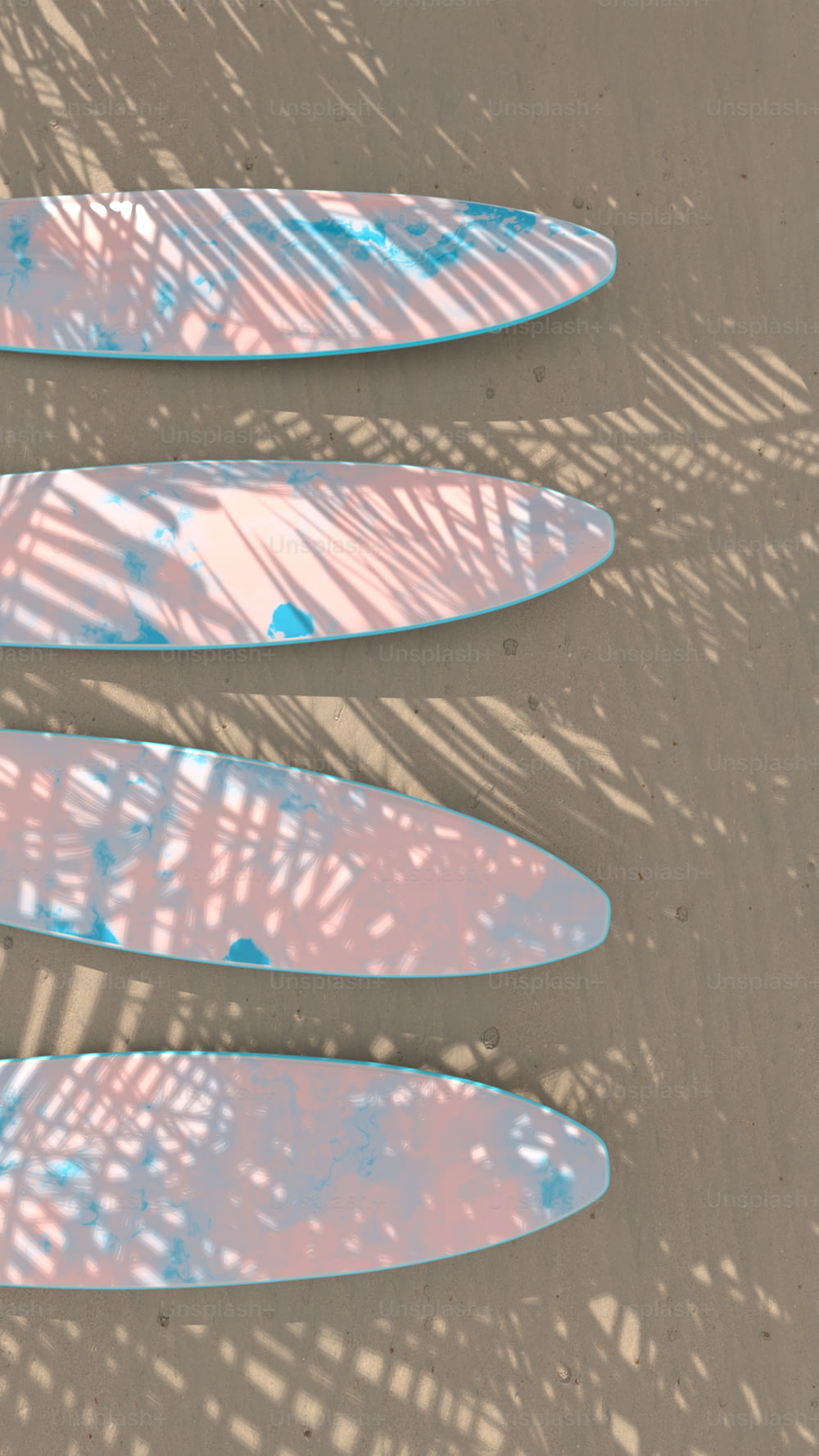a group of surfboards laying on top of a sandy beach