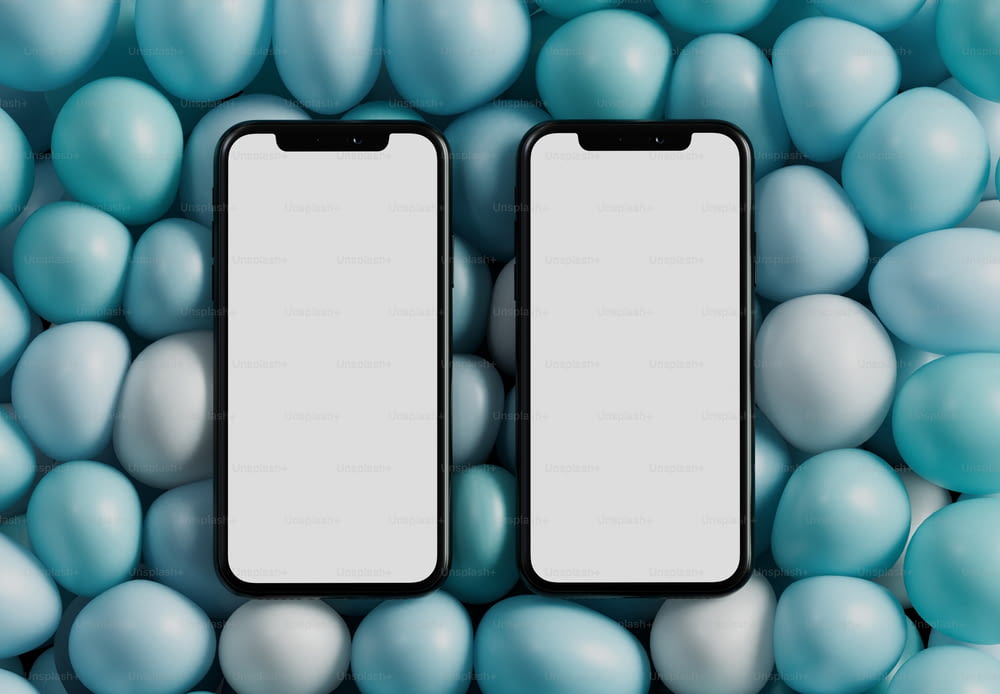 Dos teléfonos celulares negros rodeados de bolas azules y blancas