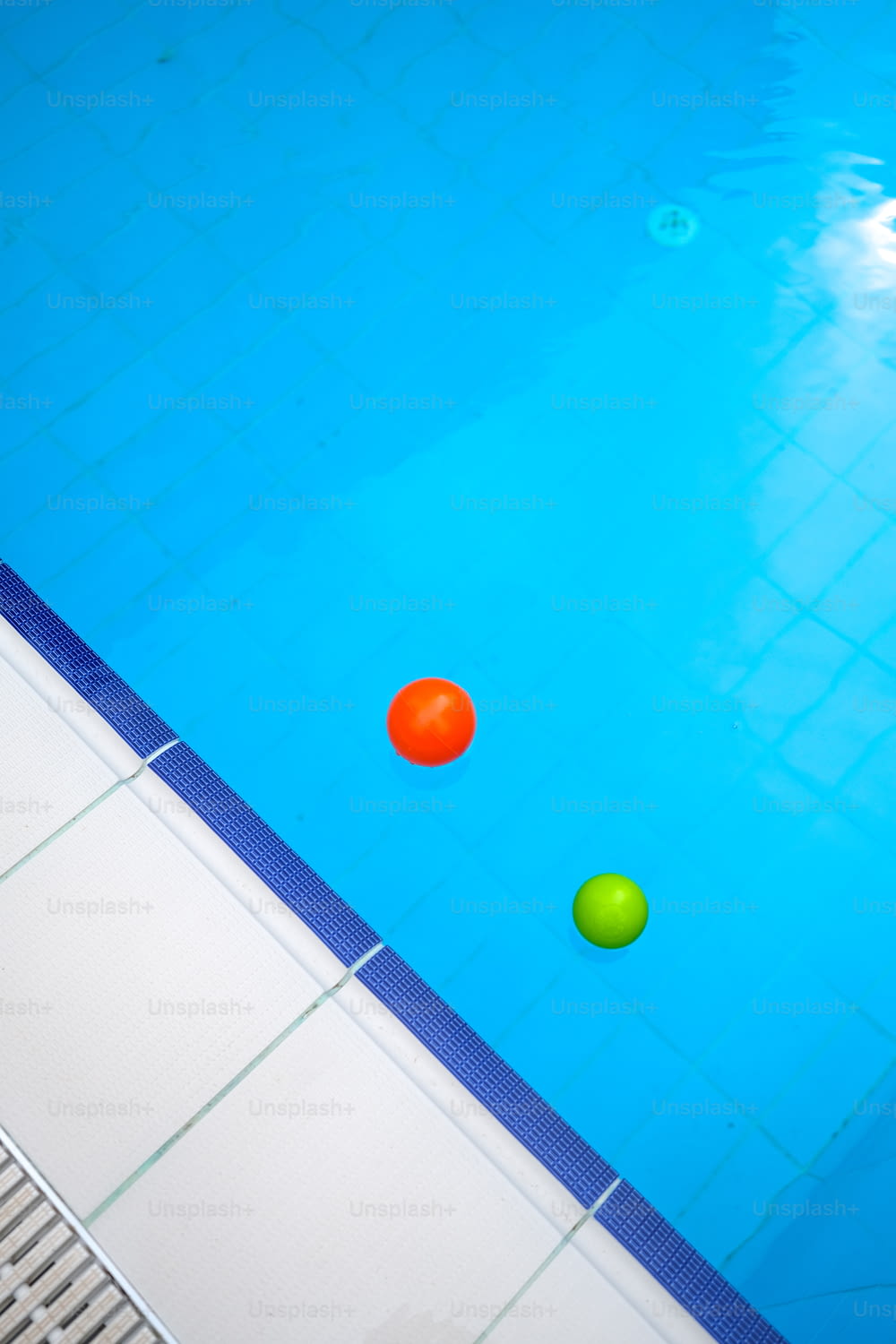 three balls floating in a swimming pool