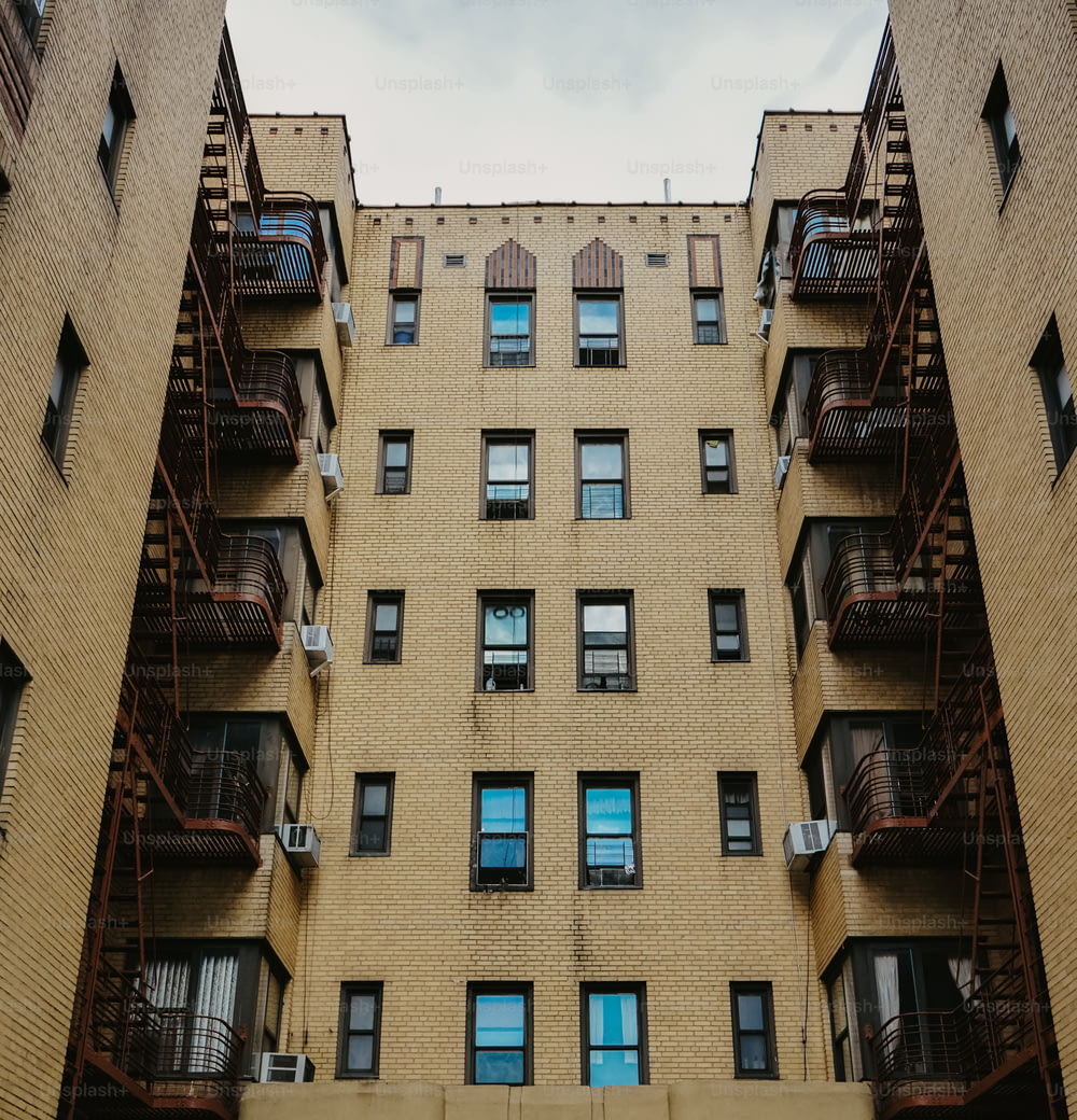 an apartment building with balconies and a fire escape
