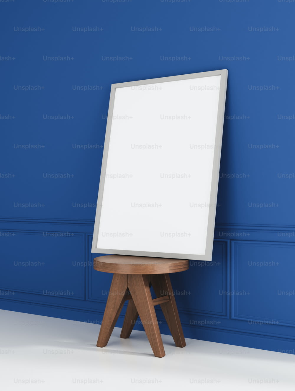 an easel stands in front of a blue wall