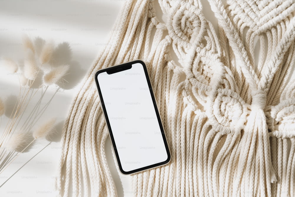 a cell phone sitting on top of a white blanket