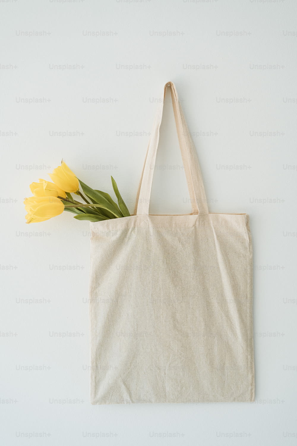 a tote bag with a yellow flower on it