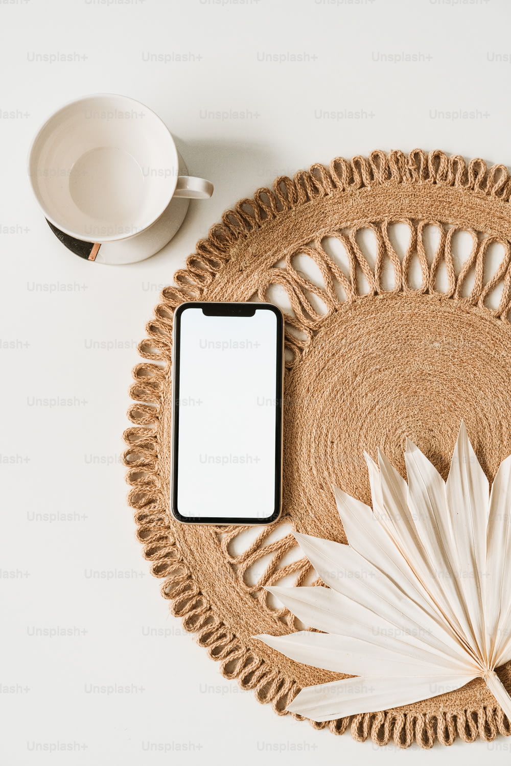 a cell phone sitting on top of a woven place mat