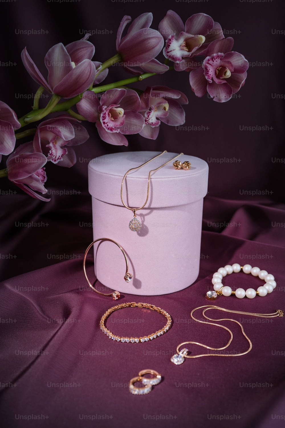 a pink box with a bunch of jewelry on top of it