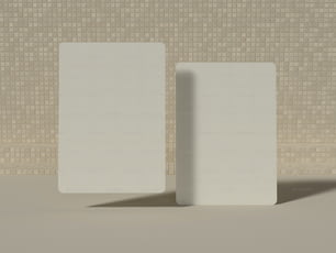 a pair of white square stands in front of a brick wall