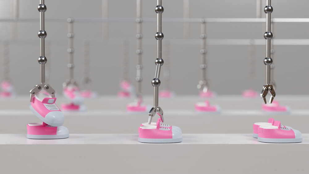 a row of pink and white shoes hanging from hooks