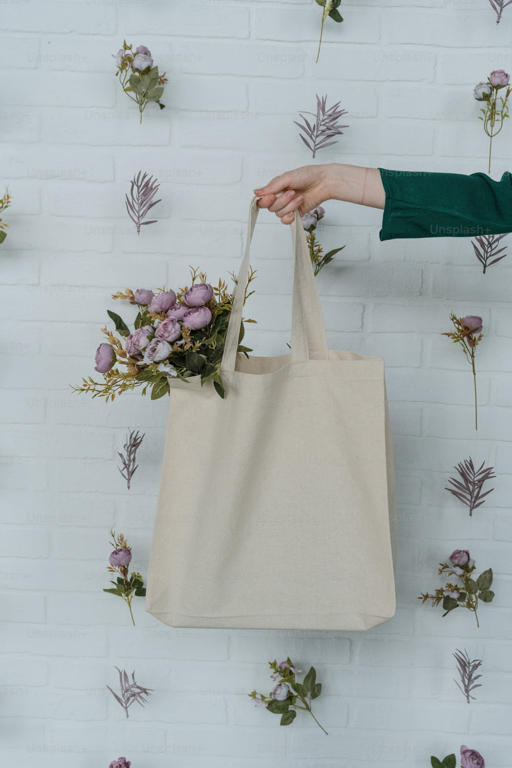 a person holding a bag with flowers on it
