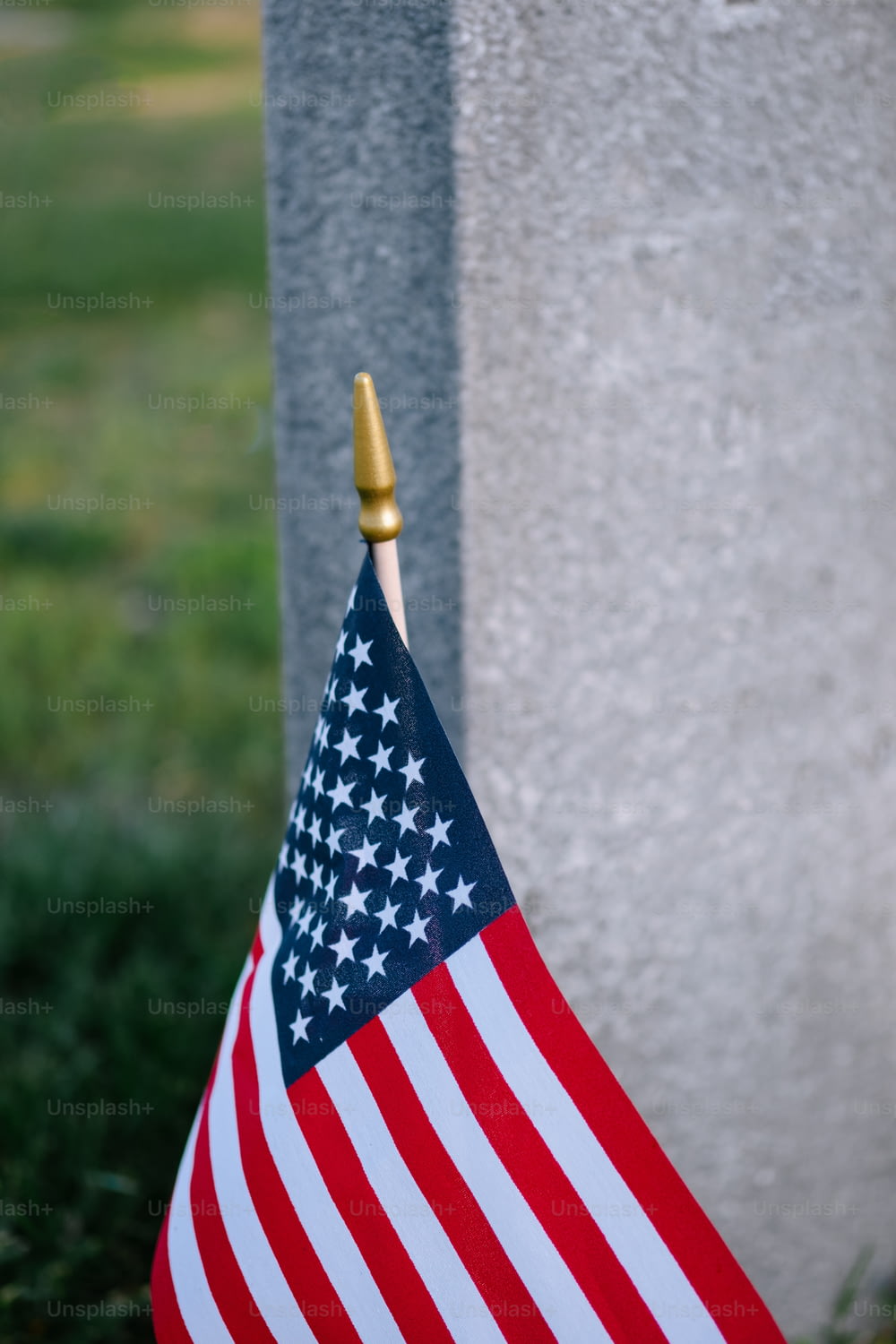 a small american flag is placed next to a grave