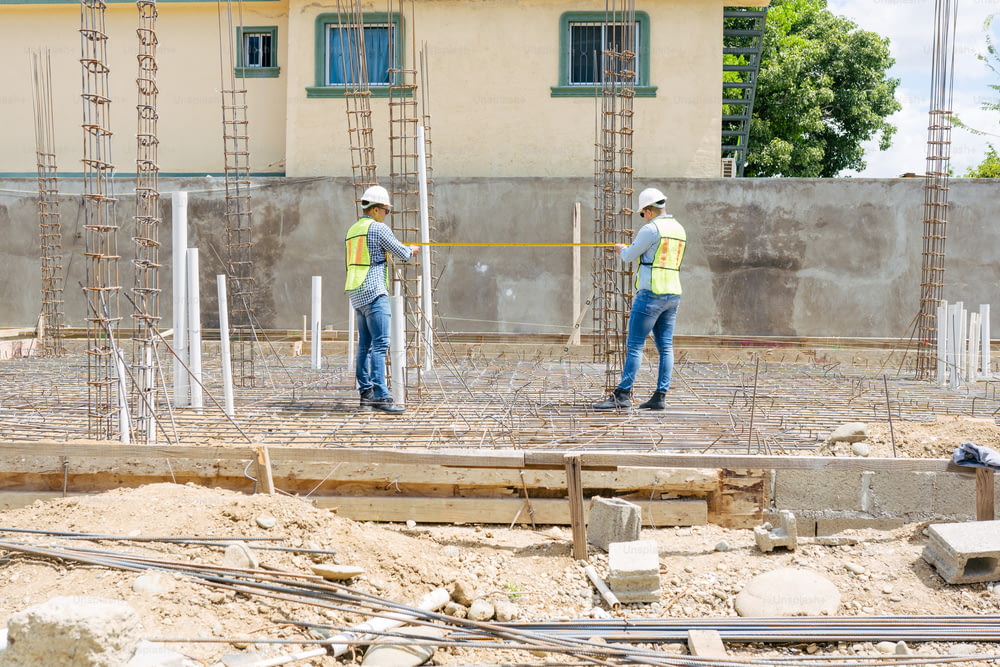 two construction workers standing on a construction site