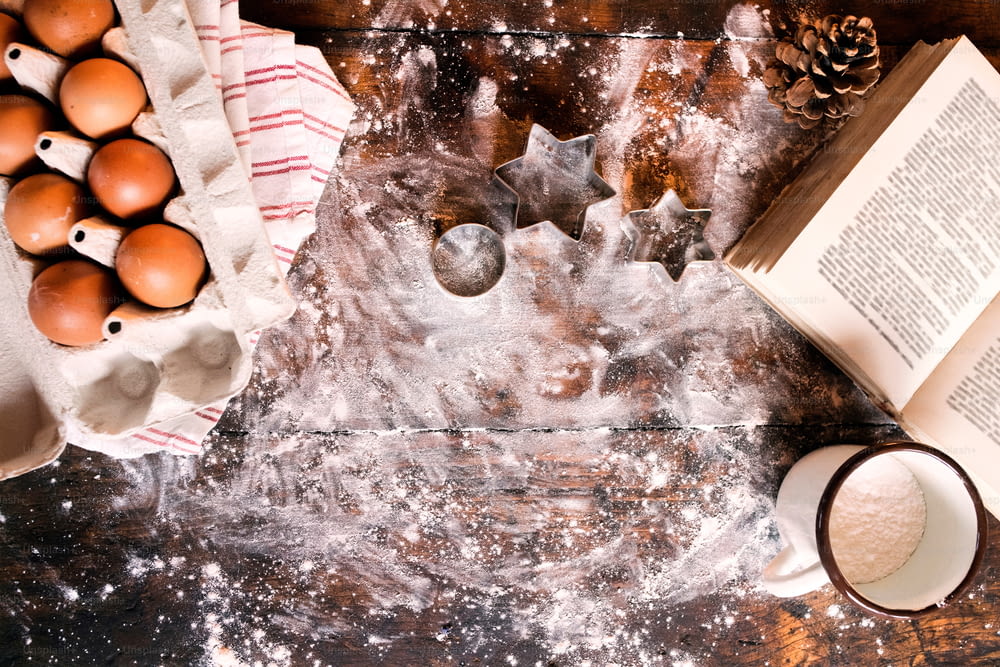 Baking gingerbread cookies at Christmas time. Ingredients on the wooden table. Overhead view. Copy space.