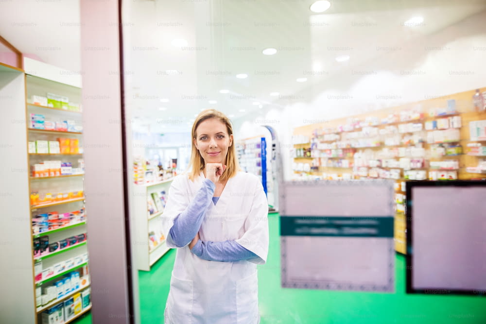 Portrait of a young beautiful friendly female pharmacist.