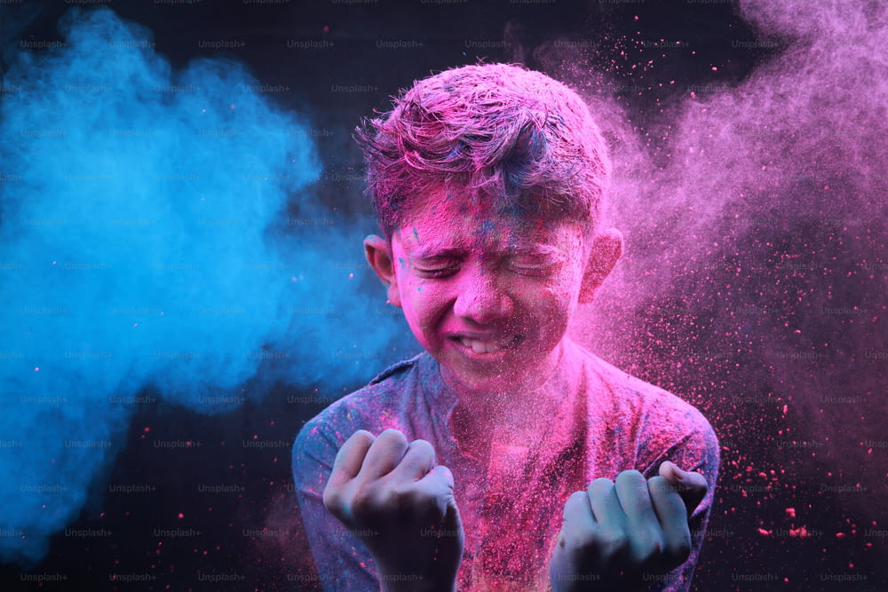 Little boy plays with colours. Concepts for Indian festival Holi