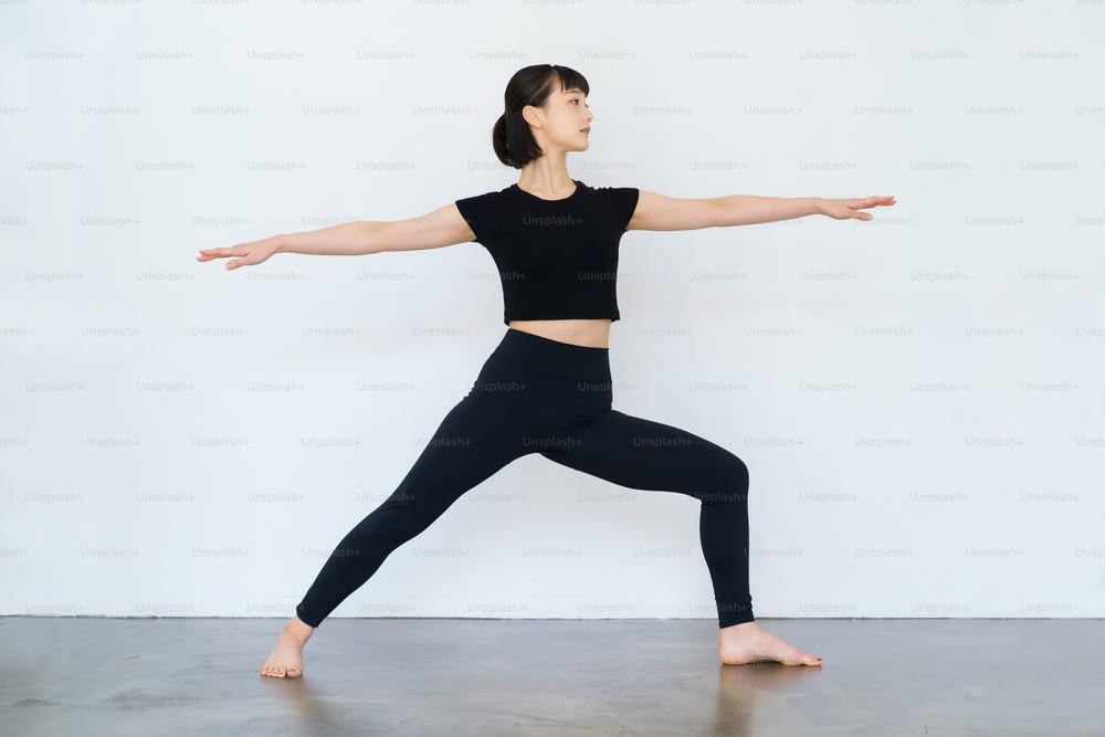 Young woman doing yoga (warrior pose)