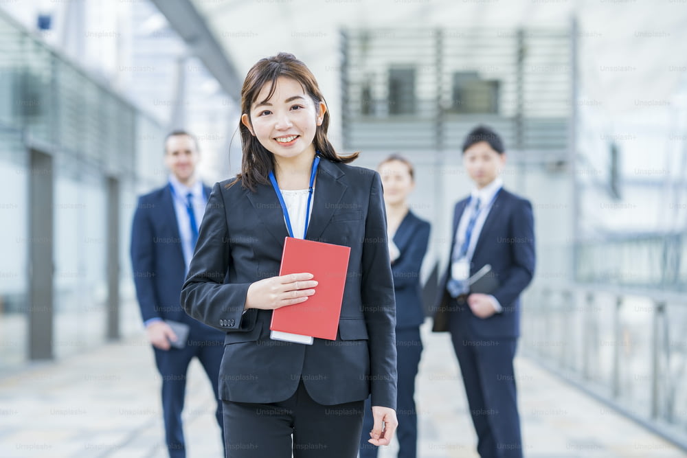 Smily asian business woman standing and her business team