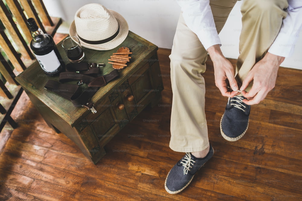 Man wearing eco flax blue shoes. Groom getting ready