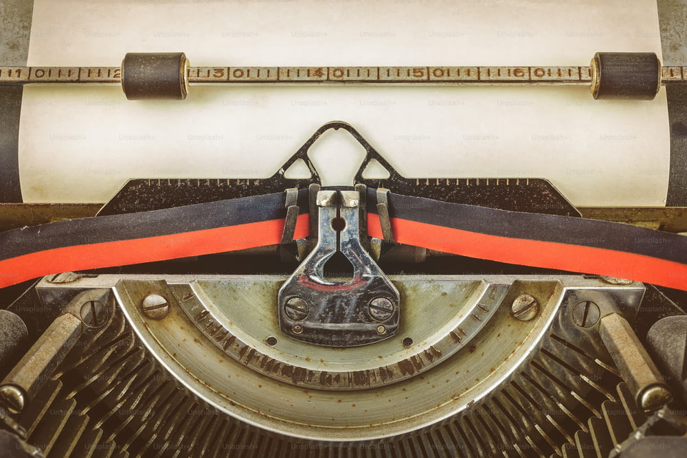 Retro styled image of a vintage typewriter with a blank sheet of paper