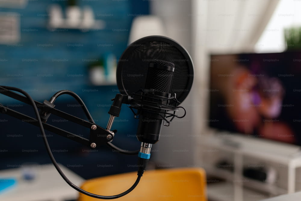 Closeup of recording microphone in home studio. Professional live broadcast equipment to record content on social media. Electronic audio livestream technology on desk. Podcast instrument.