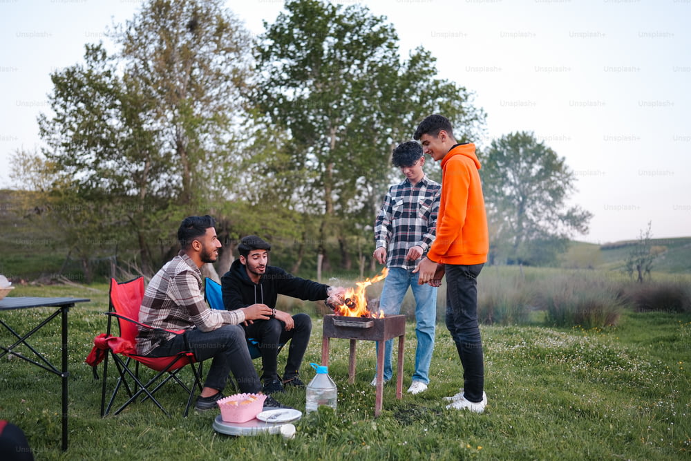 a group of people sitting around a fire pit