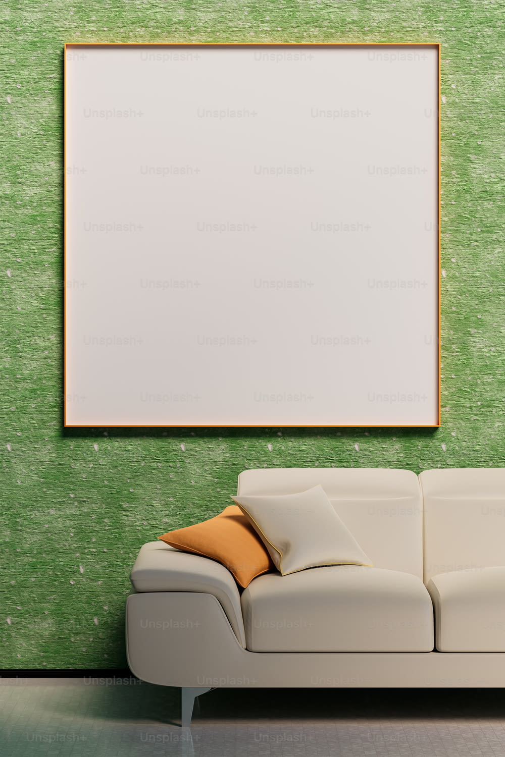 a white couch sitting in front of a green wall