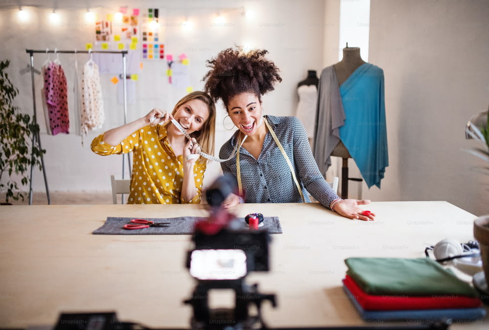 A camera with a slider and creative women in a studio. Startup business.