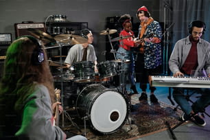 a group of people playing instruments in a room