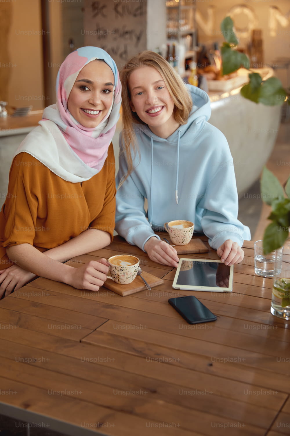 Friends. Beautiful Girls Meeting In Cafe. Smiling Women Drinking Coffee And Looking At Camera. Diversity Ethnicity Friendship.