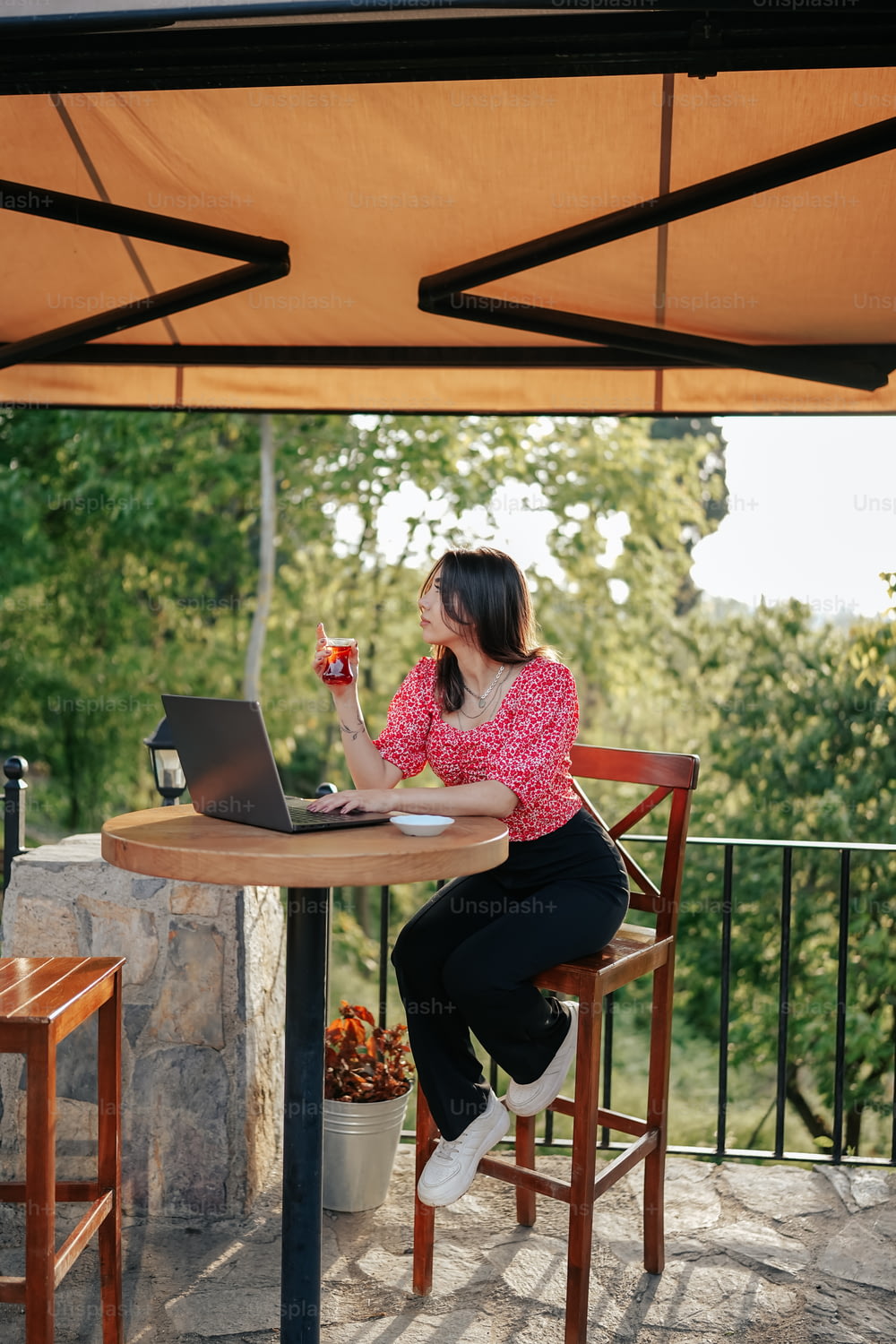uma mulher sentada em uma mesa com um laptop