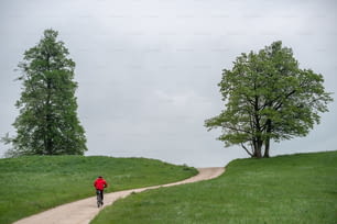 a person riding a bike down a dirt road