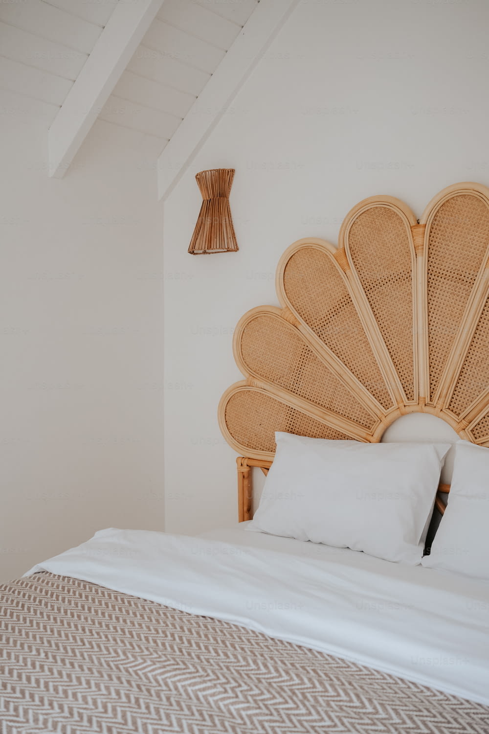 a bed with a large headboard made of wicker