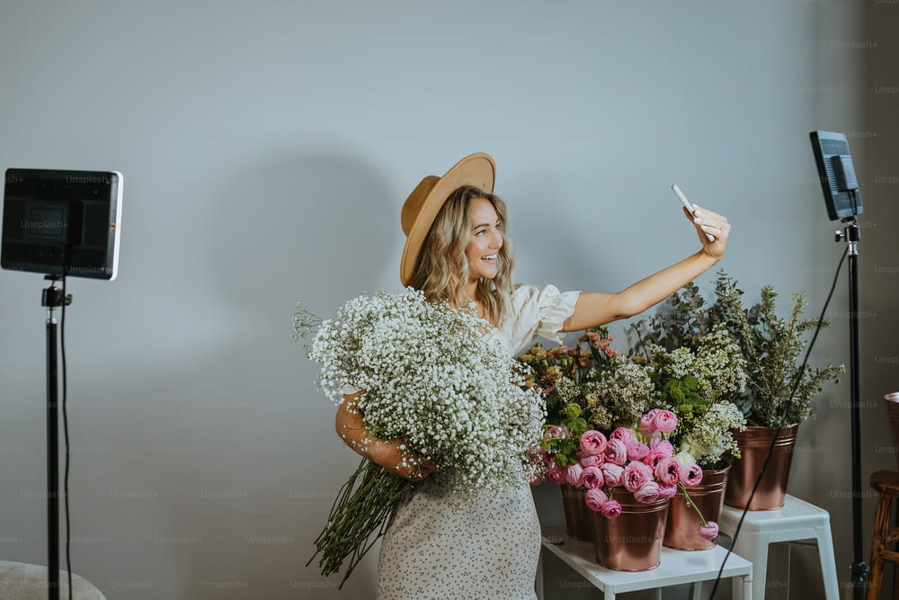 a woman holding a bunch of flowers in front of a camera