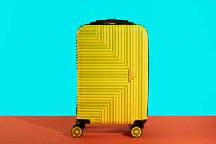 a yellow piece of luggage sitting on top of a table
