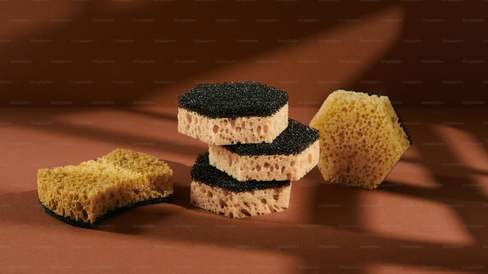 a group of sponges sitting on top of a brown surface