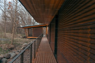 a wooden walkway leading to a building in the woods