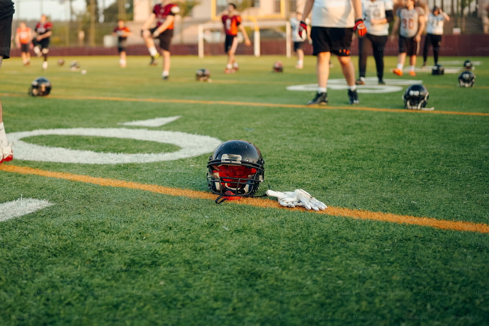 a football helmet laying on the side of a field