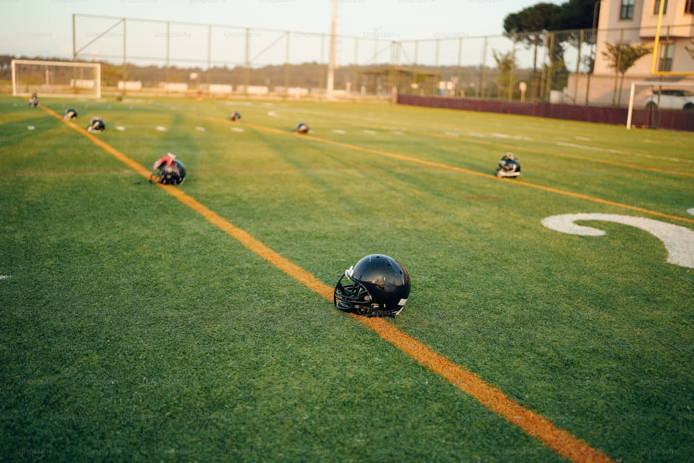 a football field with several helmets on it