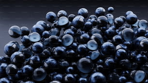 a pile of shiny blue balls on a black background