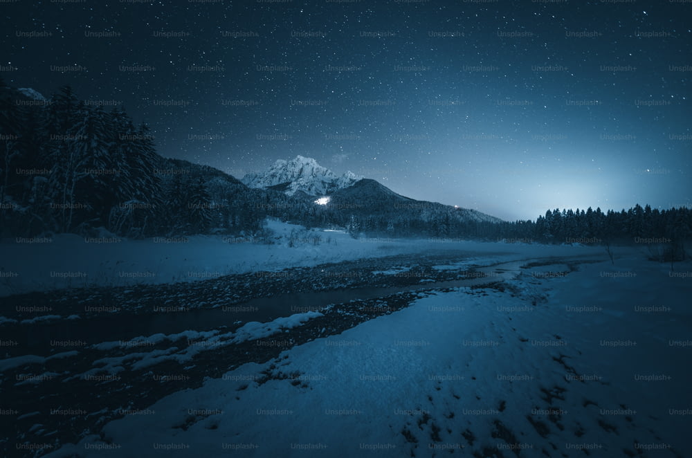 a night scene of a river and a mountain