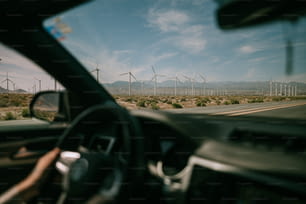 a view of a wind farm from inside a car