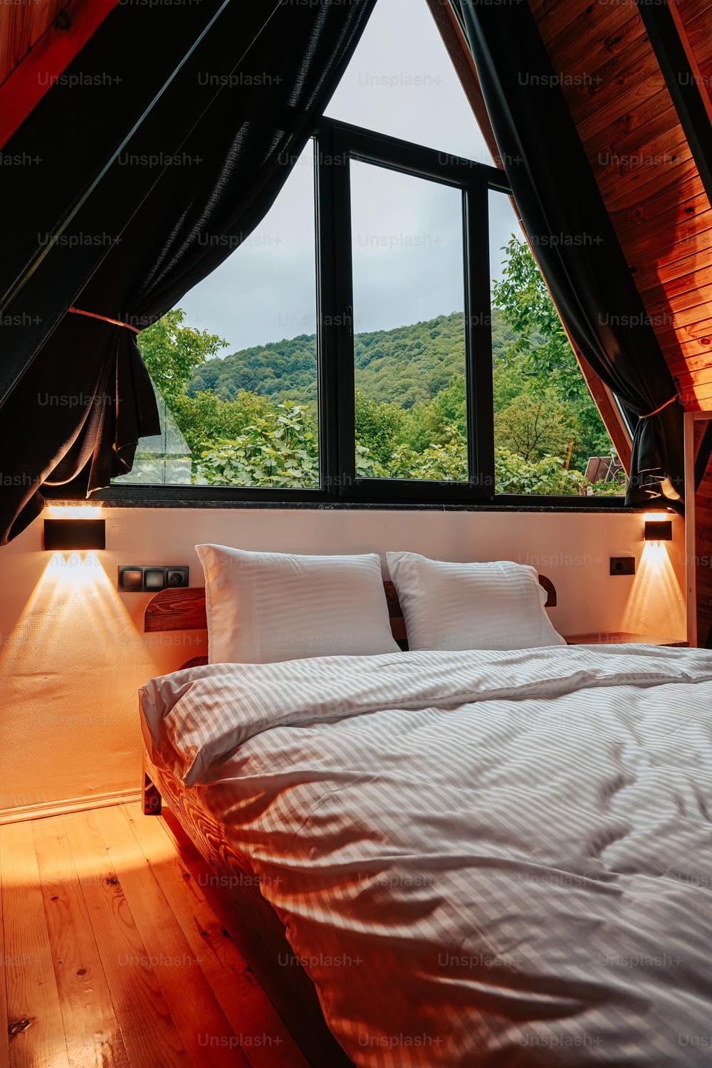 a bed sitting under a window in a bedroom