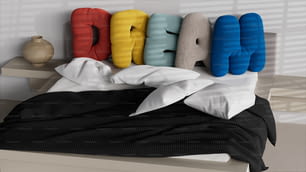 a bed with pillows and pillows on top of it