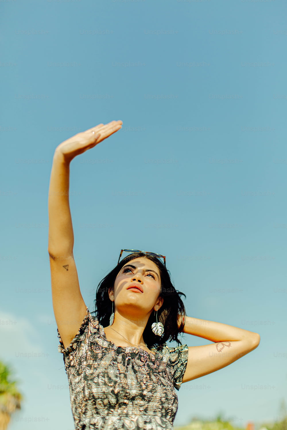a woman is holding her arms up in the air