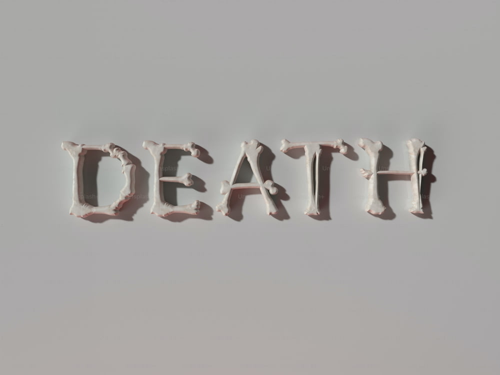 the word death spelled with white frosting on a gray background