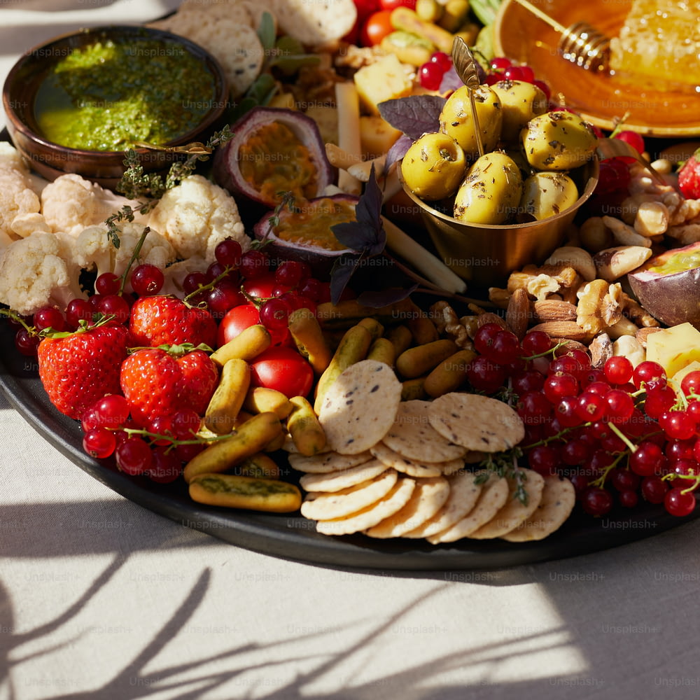 a platter filled with fruit and crackers