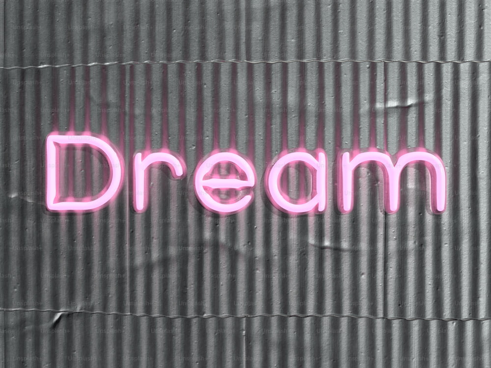 Un'insegna al neon che dice sogno su un muro
