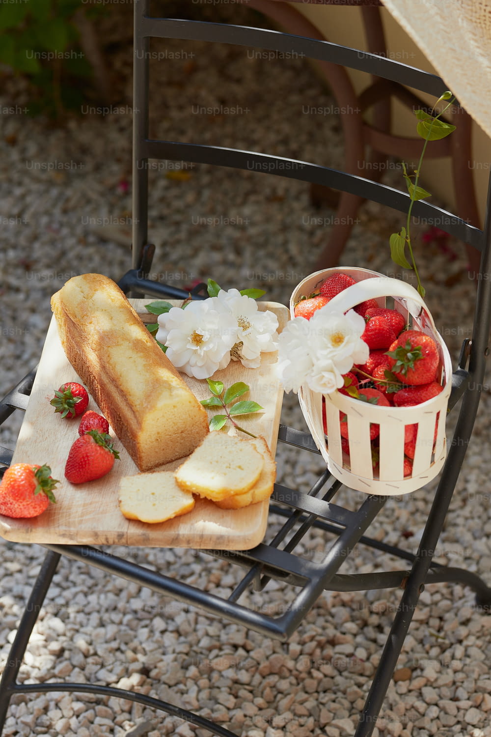 a wooden cutting board topped with sliced bread and strawberries
