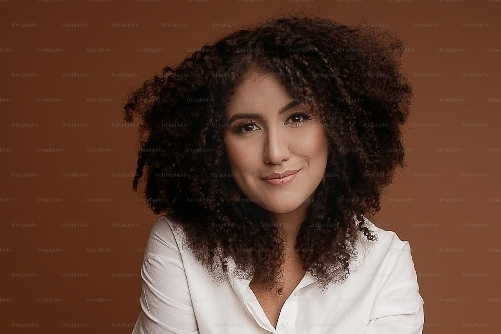 a woman with a white shirt and curly hair