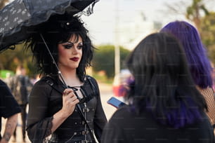 a woman with purple hair holding an umbrella
